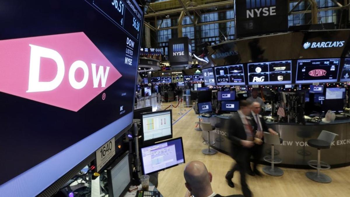 In this Dec. 9, 2015 file photo, the company names of Dow, left, and Dupont, right, appear above their trading posts on the floor of the New York Stock Exchange. DuPont and Dow Chemical said Friday, June 10, 2016 that they will hold separate shareholder meetings next month to vote on their merger. Both meetings will be held on July 20. DuPont's meeting will take place at its Wilmington, Delaware, headquarters, and Dow Chemical's meeting will be at its Midland, Michigan, offices.