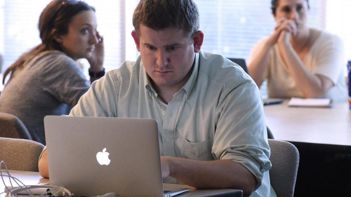 Evan Dudley works on computer coding during a “crash course” in computer programing hosted by The Iron Yard in 2015.