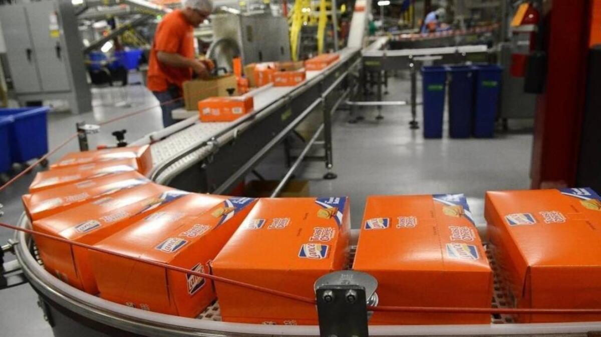Cartons of Toast Chee head to being packed in cases for shipping on a tour of the Charlotte facility in 2015. In what is likely its last earnings report as a standalone company, the Charlotte snack maker Snyder’s-Lance reported a slump in first-quarter sales.