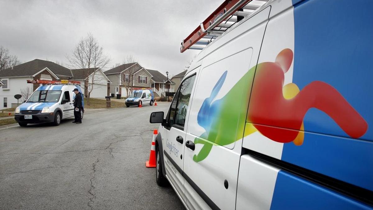 Installers for Google Fiber confer while working, March 19, 2013, in the Piper area of northwest Kansas City, Kansas.
