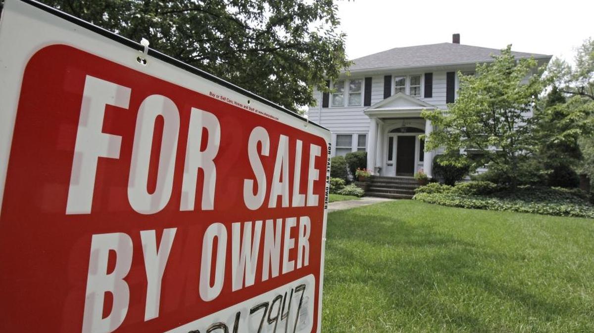 In this 2009, file photo, a “For Sale by Owner” sign rests in front of a house in Cleveland Heights, Ohio.