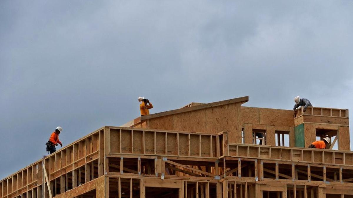 In this file photo, construction workers work under a cloudy sky in Charlotte.
