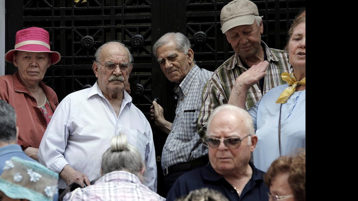 
Pensioners gather outside a closed main branch of the National Bank of Greece in Thessaloniki as the country’s debt crisis mounted.
