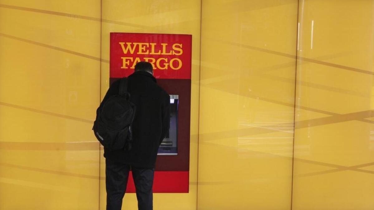 A customer uses an ATM outside a Wells Fargo branch in Charlotte.