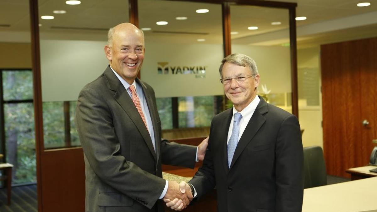
Yadkin Bank CEO Scott Custer, left, poses with NewBridge Bank CEO Presley Ridgill. On Tuesday, Raleigh-based Yadkin announced plans to acquire Greensboro-based NewBridge Bank and its 42 branches for stock valued at $456 million.
