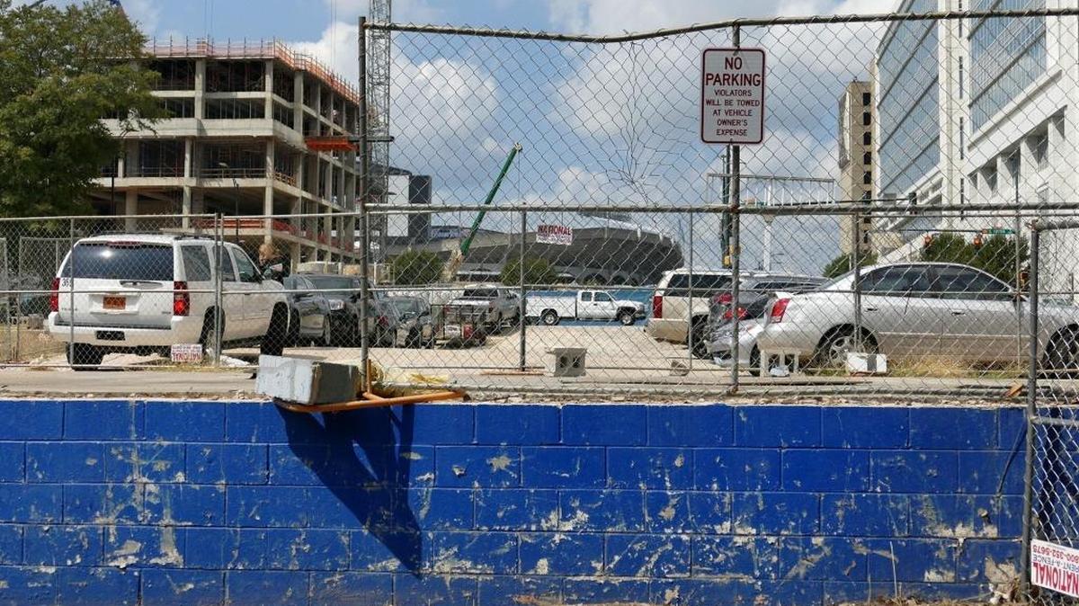 Cars parked at the old Goodyear store site at the corner of West Stonewall and South Tryon streets. On Sept. 20, 2017, Ally Financial said it will occupy more than half of a 26-story, 742,000 square-foot office tower to be built at the site.