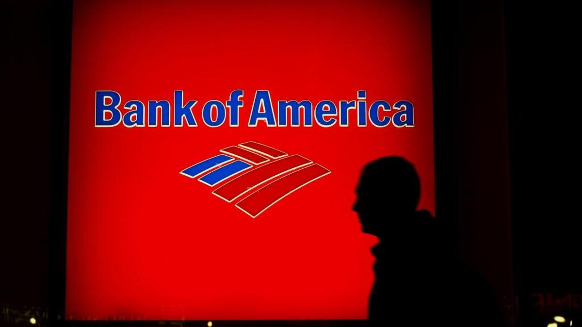 The silhouette of a pedestrian is seen walking past a Bank of America Corp. branch at night in New York.