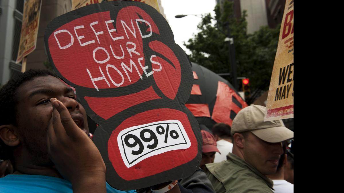 
Protesters block an intersection as they march on the Bank of America headquarters in Charlotte on May, 2012. Police aren’t expecting large-scale protests this year.
