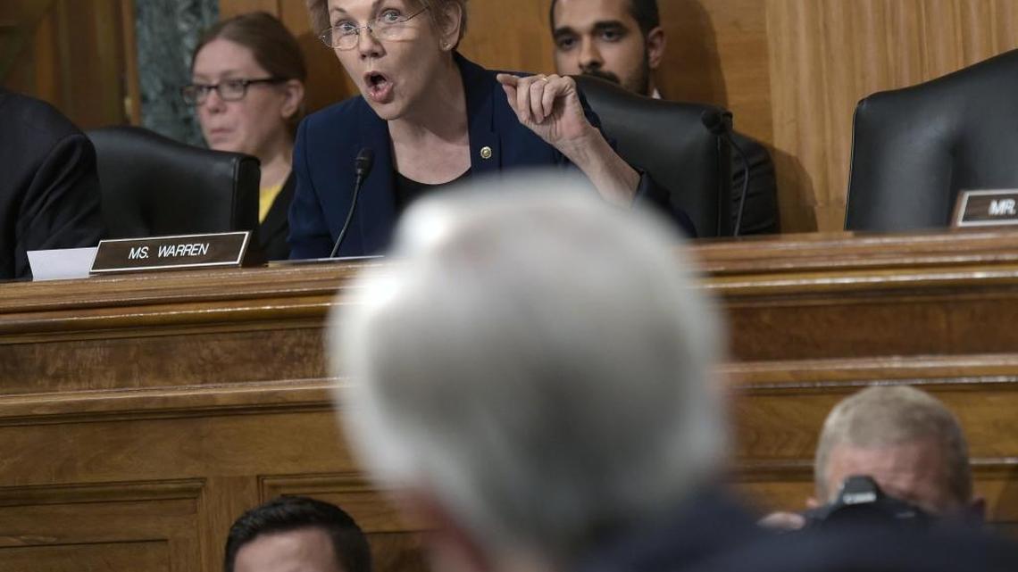Sen. Elizabeth Warren, D-Mass., center, questions then-Wells Fargo CEO John Stumpf, foreground, in Washington on Sept. 20, 2016, during a hearing on the bank’s sales scandal.