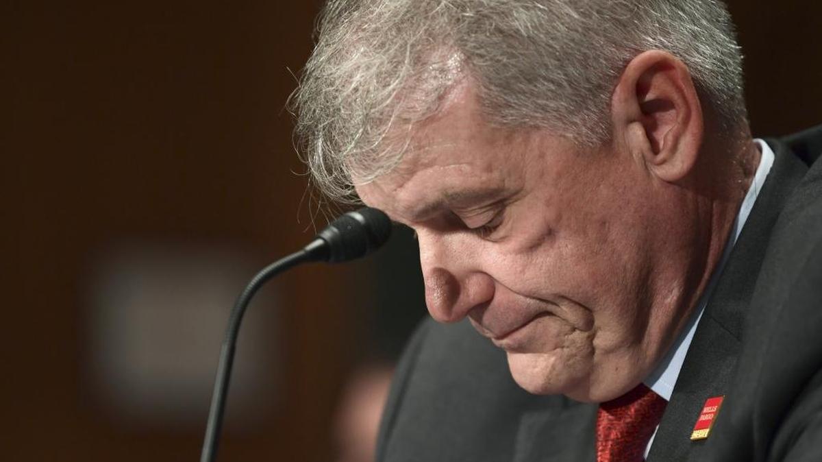 Wells Fargo CEO Timothy Sloan looks down as Sen. Elizabeth Warren, D-Mass., questions him during a Senate committee hearing in October 2017.
