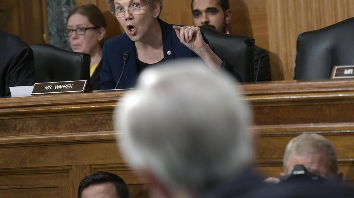 Sen. Elizabeth Warren, D-Mass., center, questions Wells Fargo’s then-CEO John Stumpf on Capitol Hill on Sept. 20, 2016.
