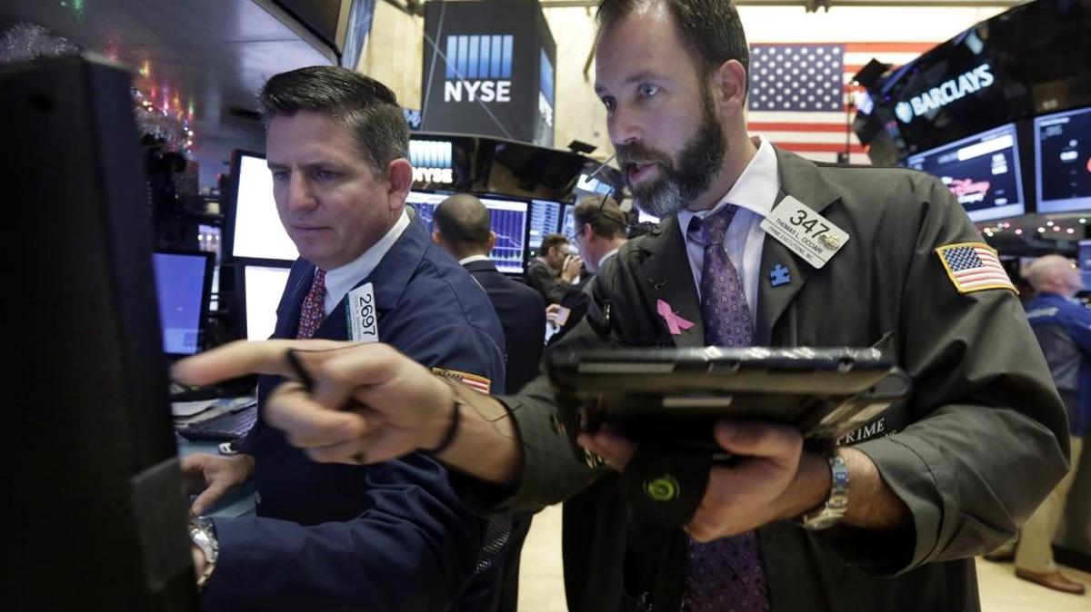 Specialist Todd Abrahal, left, and trader Thomas Cicciari work on the floor of the New York Stock Exchange, Tuesday, Dec. 15, 2015. Stocks are climbing in early trading as buyers return to a market that has been mostly beaten down in recent days.