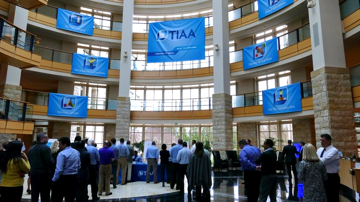 Lots of new banners and signs greet employees as they stand in line for new ID badges on the day that TIAA-CREF officially changed its name to TIAA in February.
