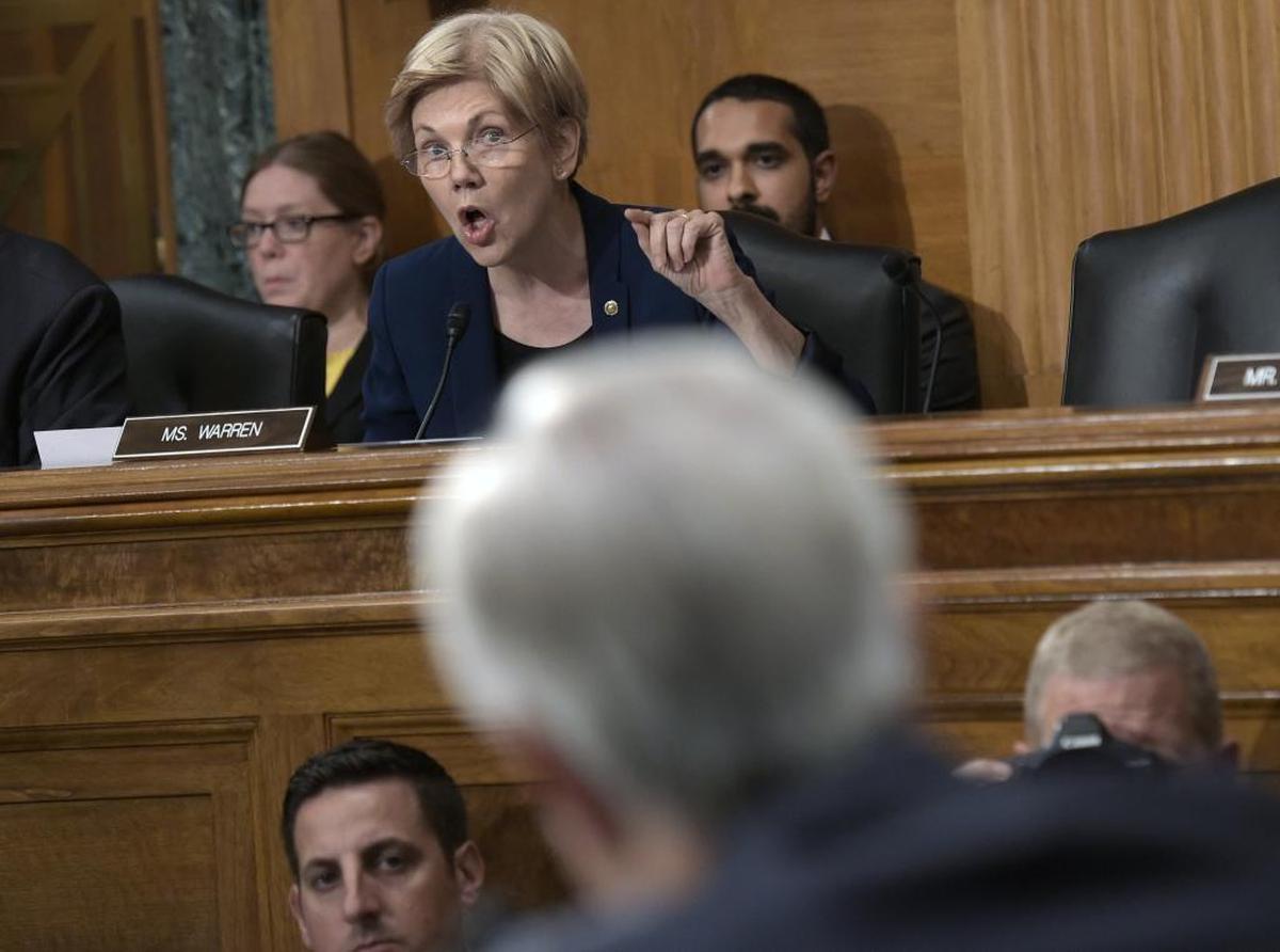 Senate Banking Committee member Sen. Elizabeth Warren, D-Mass., center, questions Wells Fargo CEO John Stumpf, foreground, on Capitol Hill in Washington last September.