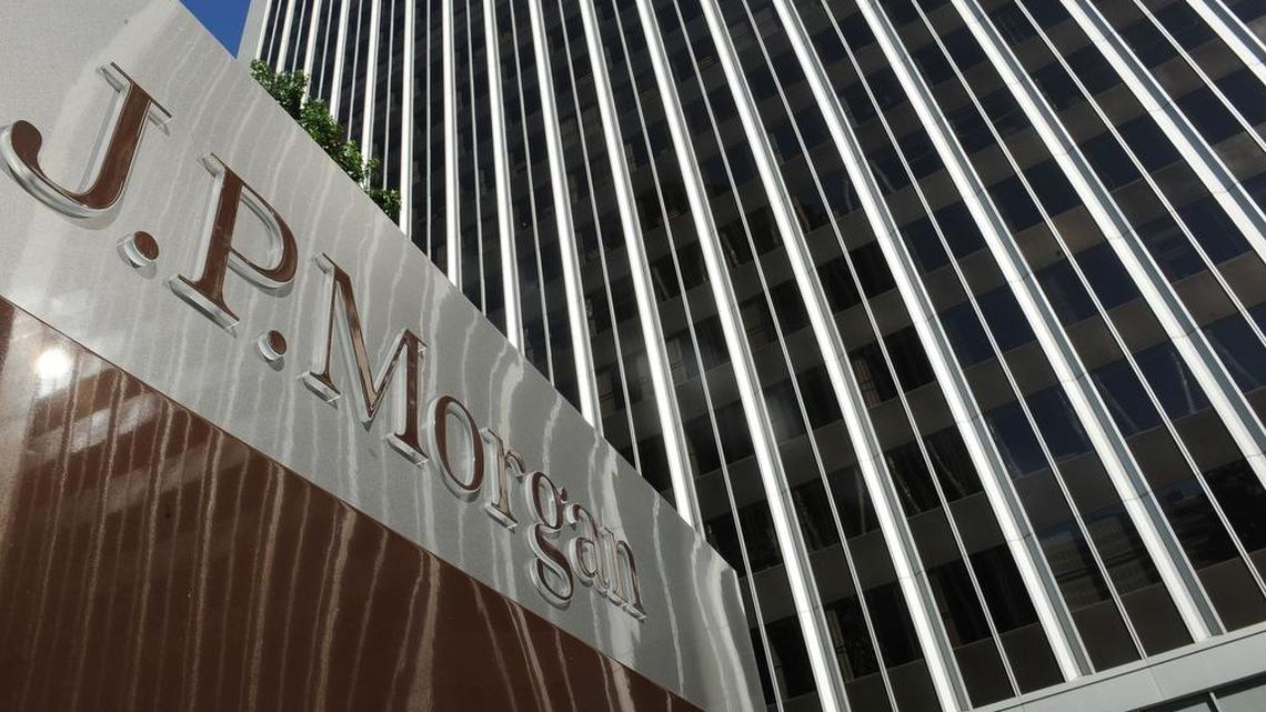 This file photo shows a JPMorgan sign outside the office tower housing the financial services firm’s Los Angeles offices.