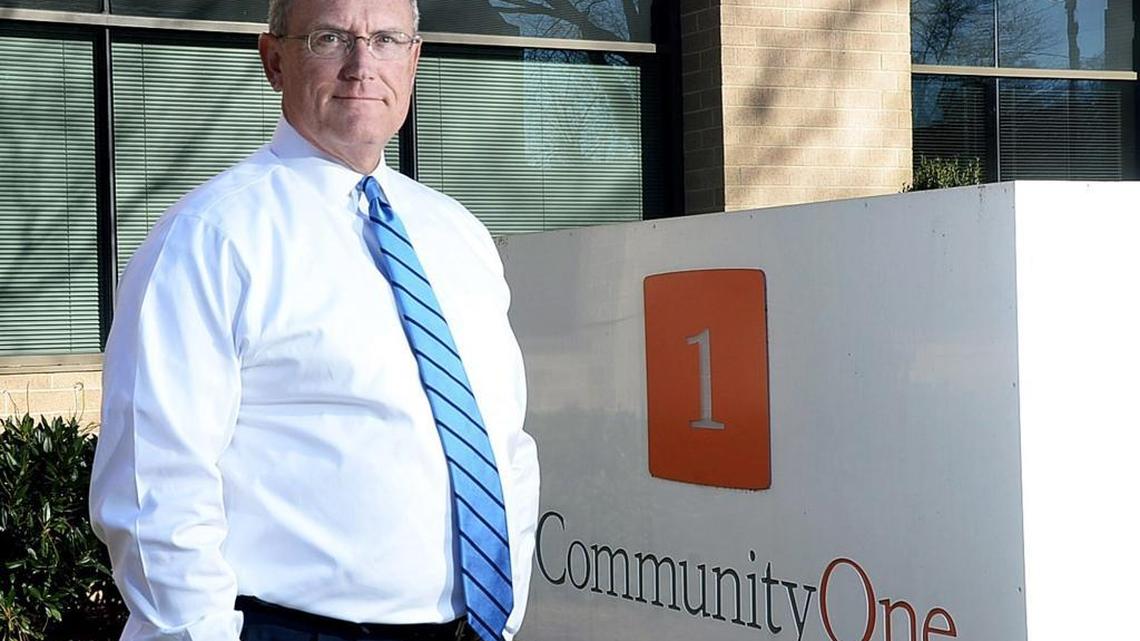 CommunityOne Bancorp President Bob Reid in front of the bank's Charlotte headquarters. On Monday, CommunityOne announced plans to be acquired by Florida’s Capital Bank Financial Corp.