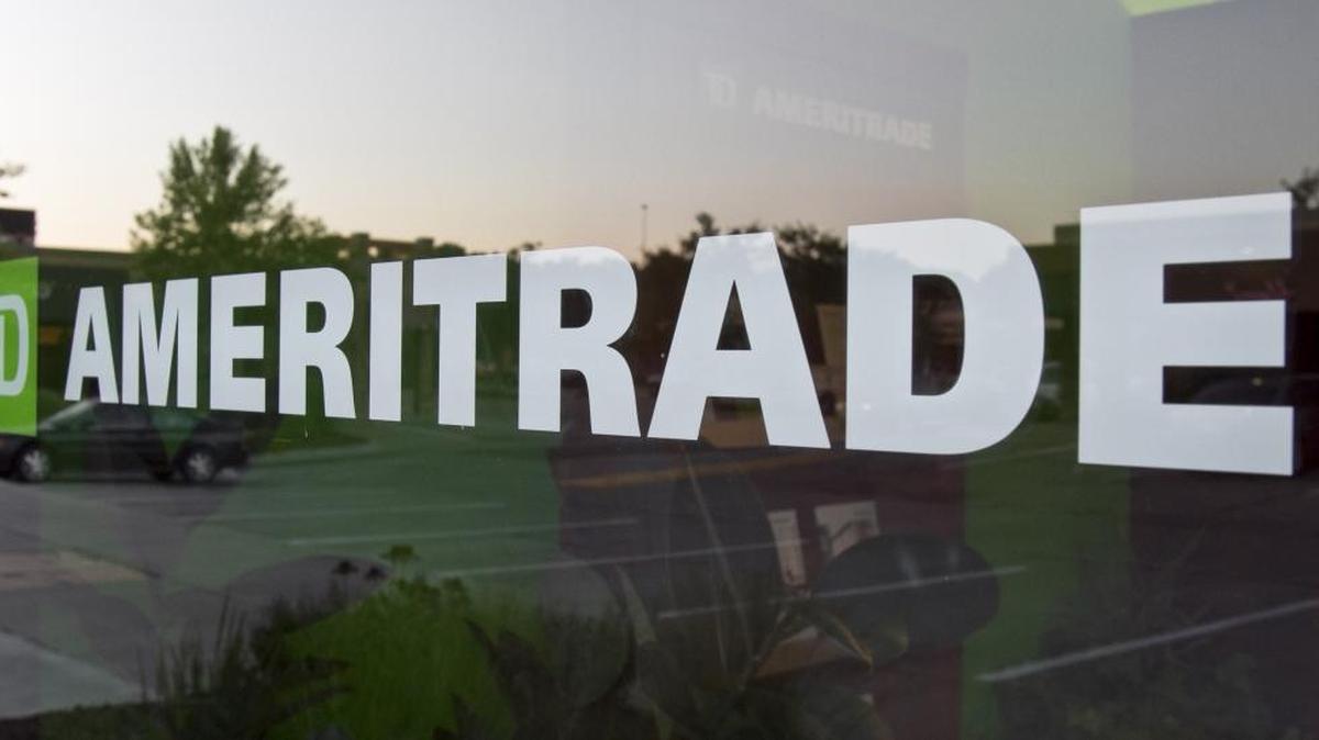 In thisfile photo, a TD Ameritrade logo is displayed on the office in Omaha, Neb. Online brokerage TD Ameritrade is buying Scottrade Financial Services Inc.