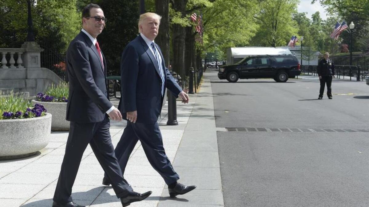 President Donald Trump and Treasury Secretary Steven Mnuchin walk back to the White House in Washington, Friday, April 21, 2017. Trump signed an executive order to review tax regulations set last year by his predecessor, as well as two memos to potentially reconsider major elements of the 2010 Dodd-Frank financial reforms passed in the wake of the Great Recession.