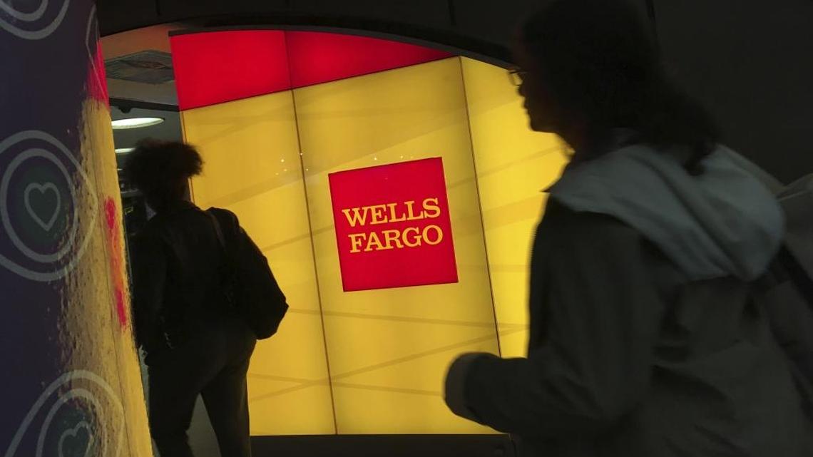 Commuters walk by a Wells Fargo ATM location at New York’s Penn Station.