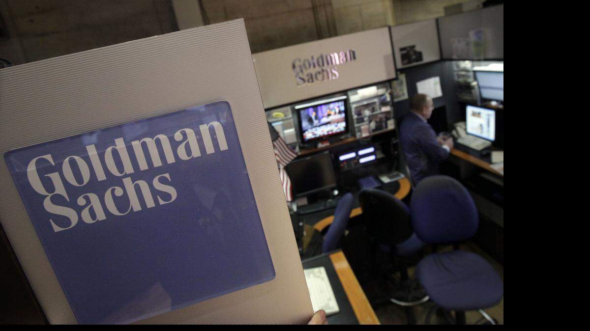 
A trader works in the Goldman Sachs booth on the floor of the New York Stock Exchange in this March 2012 file photo. Goldman Sachs Group posted the highest earnings per share in more than five years as all of its major businesses topped analysts’ estimates and the firm paid out a smaller portion of revenue to compensate employees.
