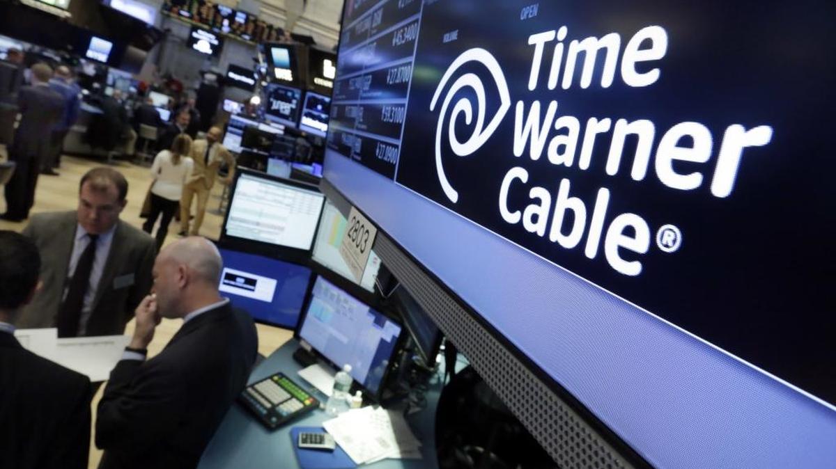 In this Tuesday, May 17, 2016, photo, the Time Warner Cable logo appears above the post where it trades on the floor of the New York Stock Exchange.
