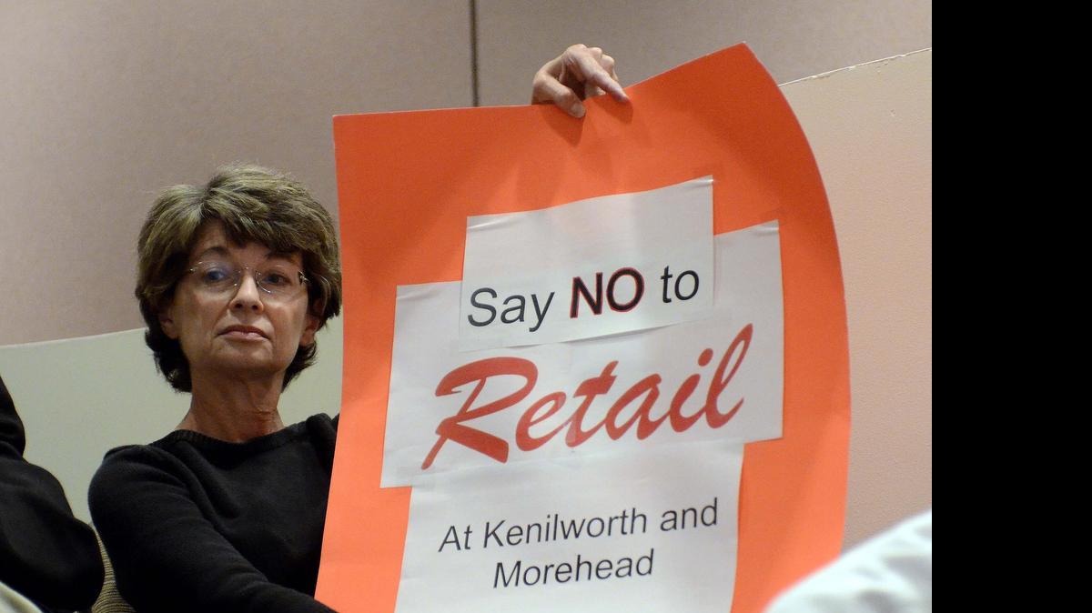 
Protest petitions such as the one Dilworth residents used to successfully fight a proposed Walgreens store at the corner of Kenilworth and Morehead could be abolished under a bill in the legislature.
Dilworth resident Janet Hall holds up a sign in protest against the proposed Walgreens at the corner of Kenilworth and East Morehead Street during Monday night's Charlotte City council meeting. 
