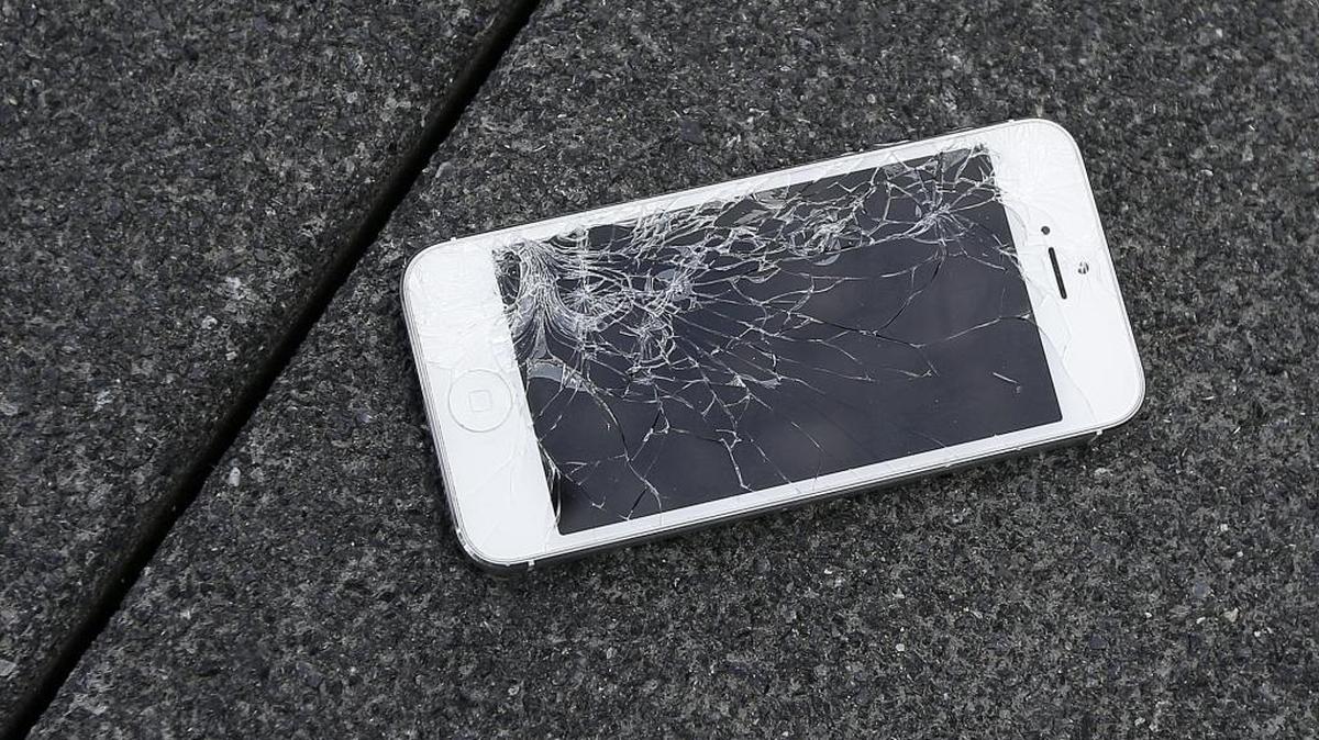 This Aug. 26 file photo shows an Apple iPhone with a cracked screen at the offices of SquareTrade in San Francisco.