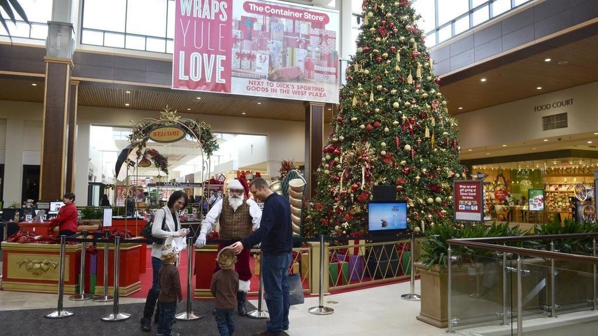 Melinda and Mark Mickholtzick brought their twin three-year-old sons Tyler and Bryce to see Santa at SouthPark Mall Thursday on November 21, 2013. After hearing “feedback” from customers, SouthPark mall reversed itself and announced Saturday it will include a traditional Christmas tree in its holiday display after all.