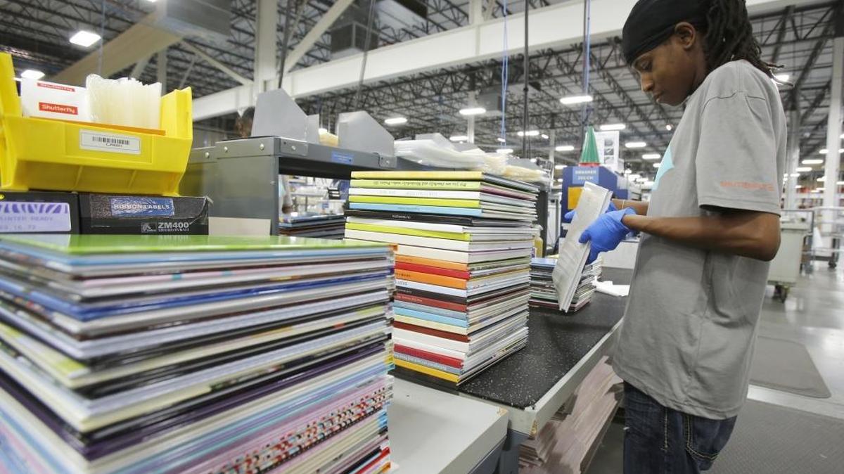 Bridgett Williams examines photo books before they are shipped to customers at Shutterfly’s facility in Fort Mill.