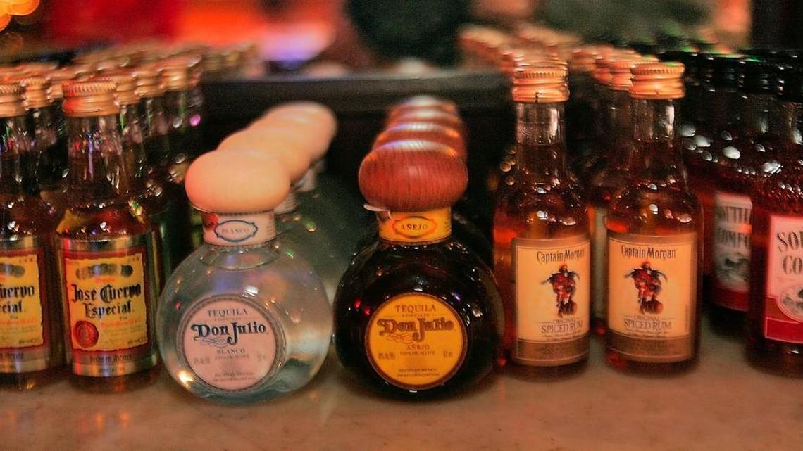 Bottles of liquor line the shelves of a liquor store.