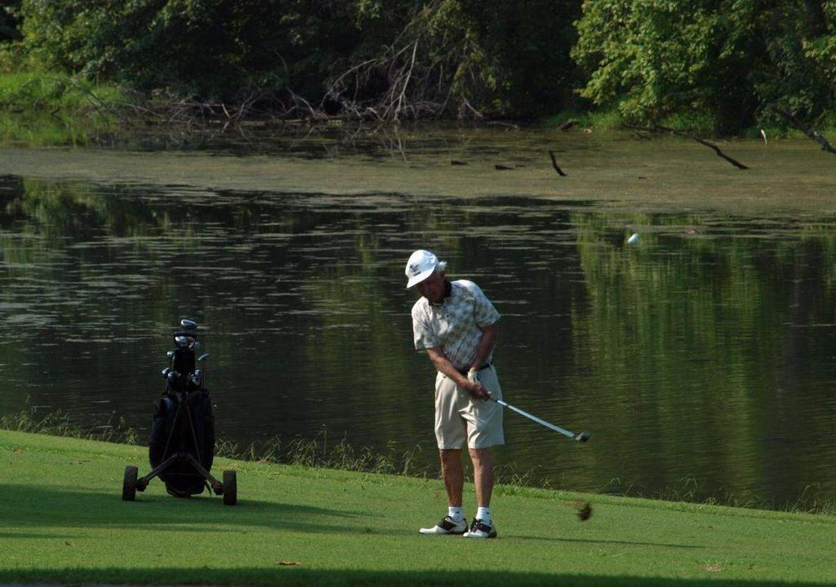 A golfer celebrating the 50th anniversary of Larkhaven, the oldest 18-hole daily fee course in Charlotte, in 2008.