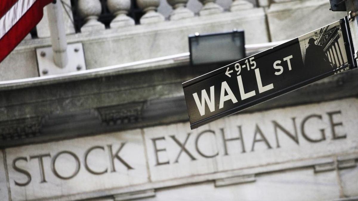 This file photo, shows a Wall Street street sign outside the New York Stock Exchange.