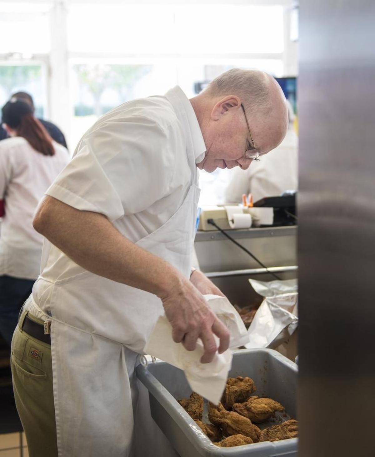 Stephen Price, co-owner of Price’s Chicken Coop in Charlotte, works during the lunch rush. “You couldn’t find as good a location, and that’s the thing,” he says.