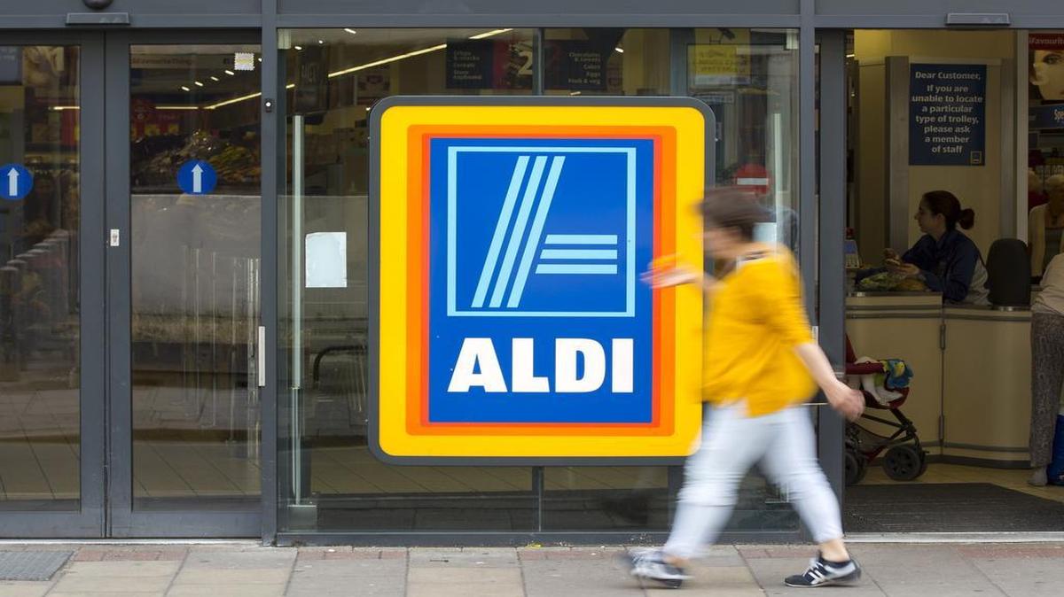 
A pedestrian walks past the entrance to an Aldi supermarket store in London.
