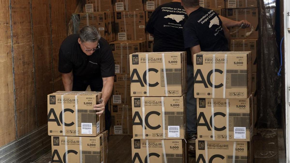Volunteers from Electrolux help to unload Frigidaire air conditioners at the Crisis Assistance Ministry Furniture Bank on Monday, July 13, 2015. The company donated more air conditioners this year.