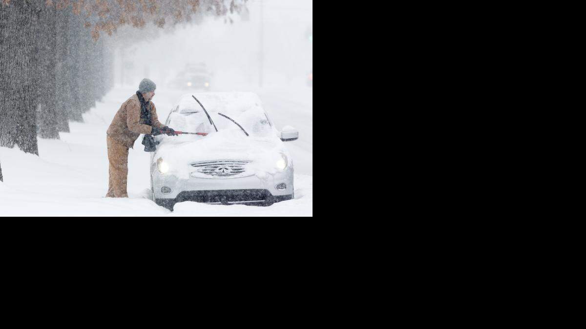 
A driver cleans snow off a car in Lexington, Ky., on Feb. 16. For retailers like Charlotte-based Cato, harsh winter storms slowed monthly sales. Cato’s February sales totaled $80.5 million, or 7 percent lower than the same month in 2014.
