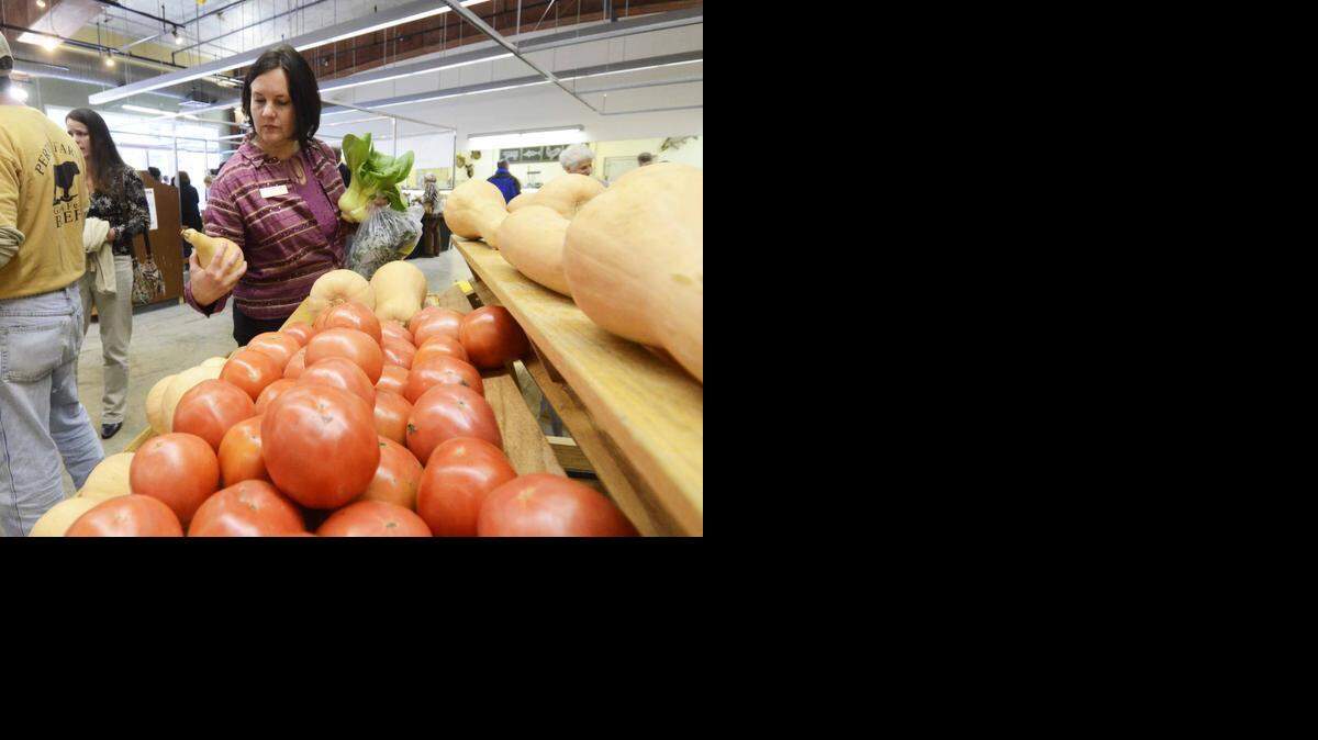 
A shopper looks over the butter nut squash at 7th Street Market, in the old Reid's at 7th Street Station. Chris Clouden has been named the new executive director for the market and will assume his new role March 30. 
