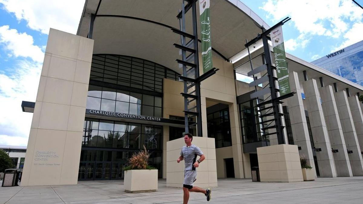 A runner passes by the Charlotte Convention Center in this photo from 2012. North Carolina’s new law limiting LGBT protections has already dissuaded some outside businesses and groups from planning events in Charlotte, the city’s tourism authority says.