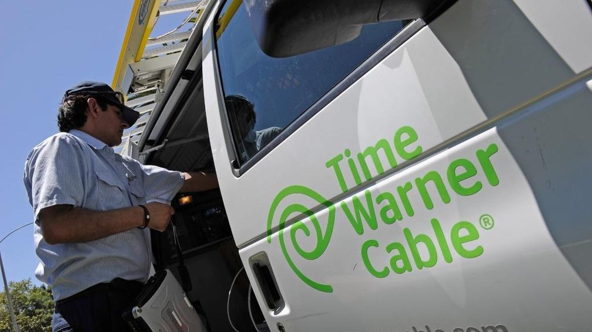 A Time Warner Cable technician works in his van after making a house call on August 3, 2011 in Los Angeles.