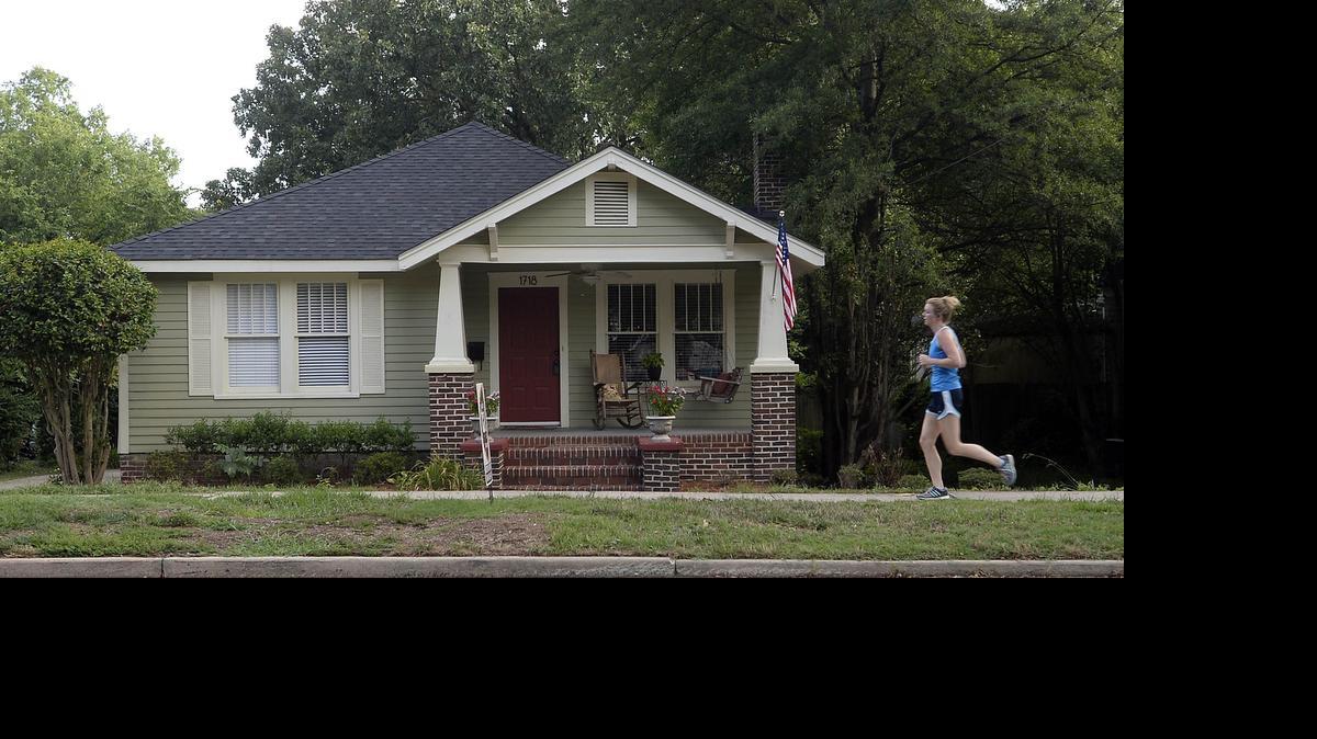 
A jogger passes by a home for sale along Mecklenburg Avenue in Charlotte’s Plaza Midwood neighborhood on July 22.
