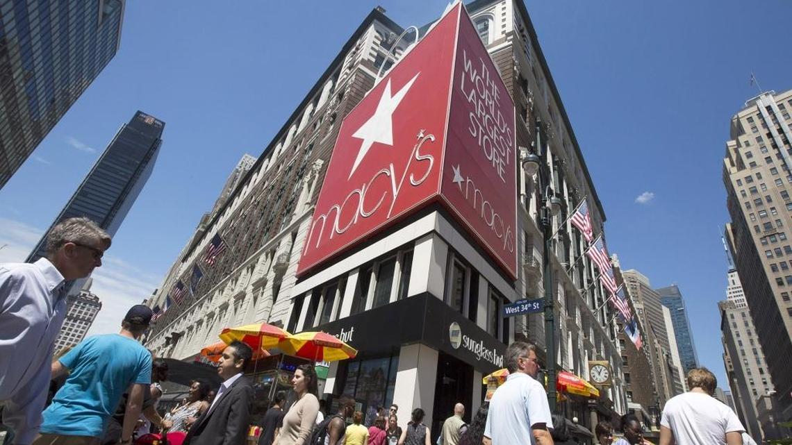 
Pedestrians walk through Herald Square past a Macy’s department store in New York. 
