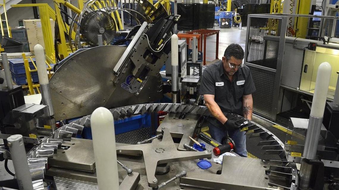 James Elrod, a machinist with Siemens, works on a turbine component on May 23, 2014. The German manufacturer is laying off “a small number” of hourly and salaried workers at its Charlotte plant.