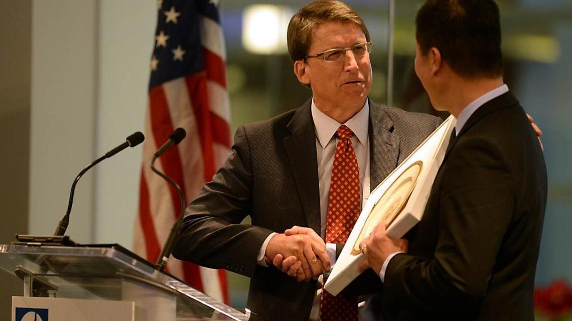 
Gov. Pat McCrory presents Jack Truong, then-CEO of Electrolux in North America, with a plate with the seal of North Carolina after Electrolux announced its expansion in Charlotte in December 2013. 
