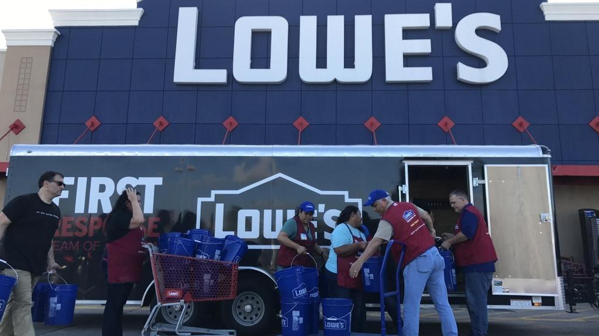Lowe’s volunteers load truckloads of supplies to send to areas in and around Houston affected by Harvey, which is now a tropical storm.