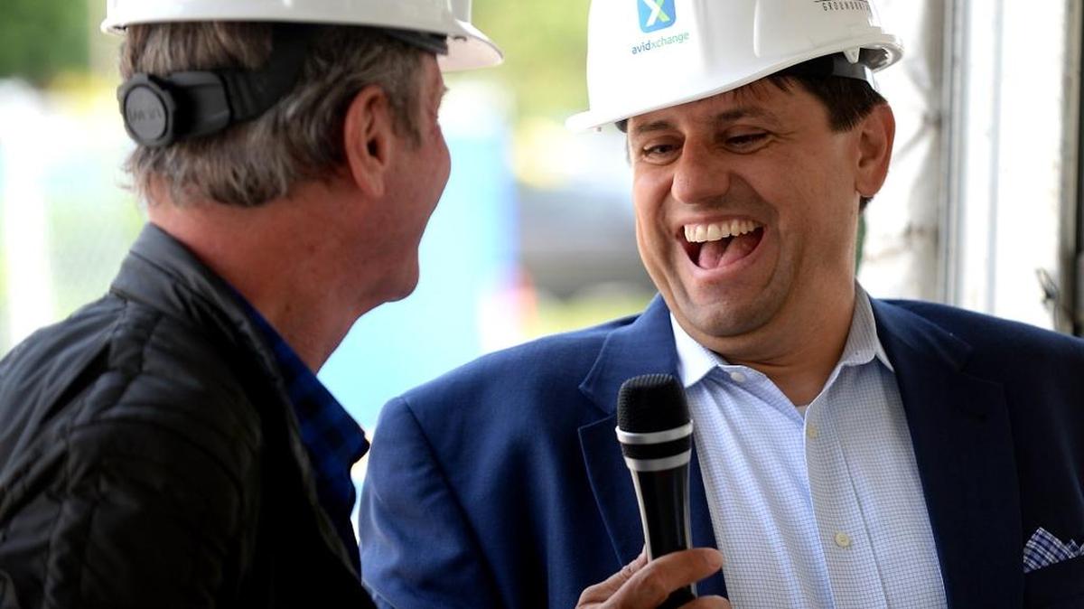 AvidXchange CEO Michael Praeger, right, laughs as he talks with Rick Lazes, left, the developer of the AvidXchange Music Factory in 2016. Avidxchange’s new headquarters is located in the AvidXchange Music Factory campus.