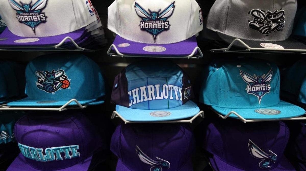 Hats with the Charlotte Hornets old and new logo are sold side by side at Lids in NorthLake Mall on June 14, 2014. The Hornets are back and merchandise is booming, but fans have mixed feelings about the new logo.