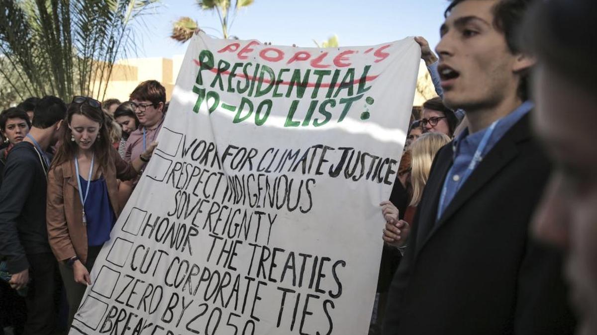 Environmental activists hold a banner during a protest against President-elect Donald Trump at the Climate Conference, known as COP22, in Marrakech, Morocco, Wednesday, Nov. 9, 2016. The election of a U.S. president who has called global warming a "hoax" alarmed environmentalists and climate scientists and raised questions about whether America, once again, would pull out of an international climate deal.