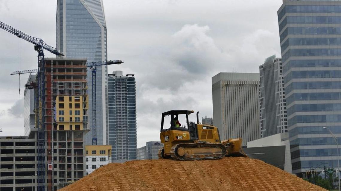 Work continues on the former the former Actor’s Theatre building site on Stonewall Street to make way an apartment building in the fastest-growing stretch of uptown. At a forum Thursday, local and national real estate experts remained bullish on the economy.