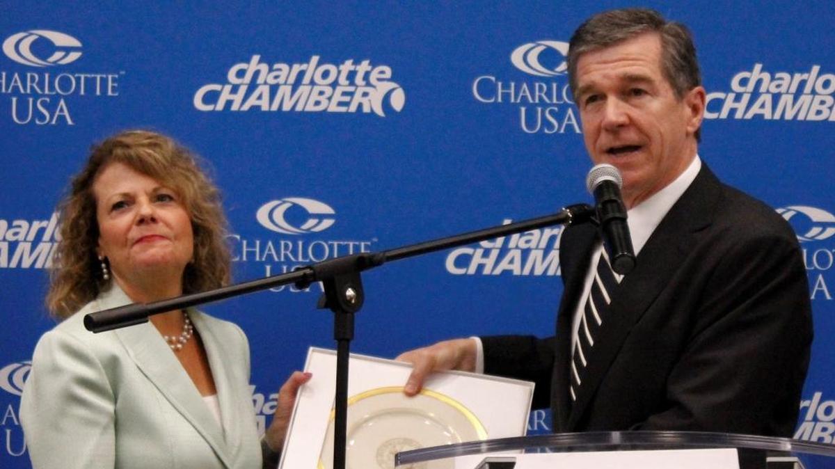 NC Gov. Roy Cooper, right, presents a plaque to Harriet Harty, executive vice president of human resources at Allstate, on Aug. 9, 2017, in Charlotte, as the company announced plans to create 2,250 local jobs by 2020. On Tuesday, that project came to an end, without creating any jobs.