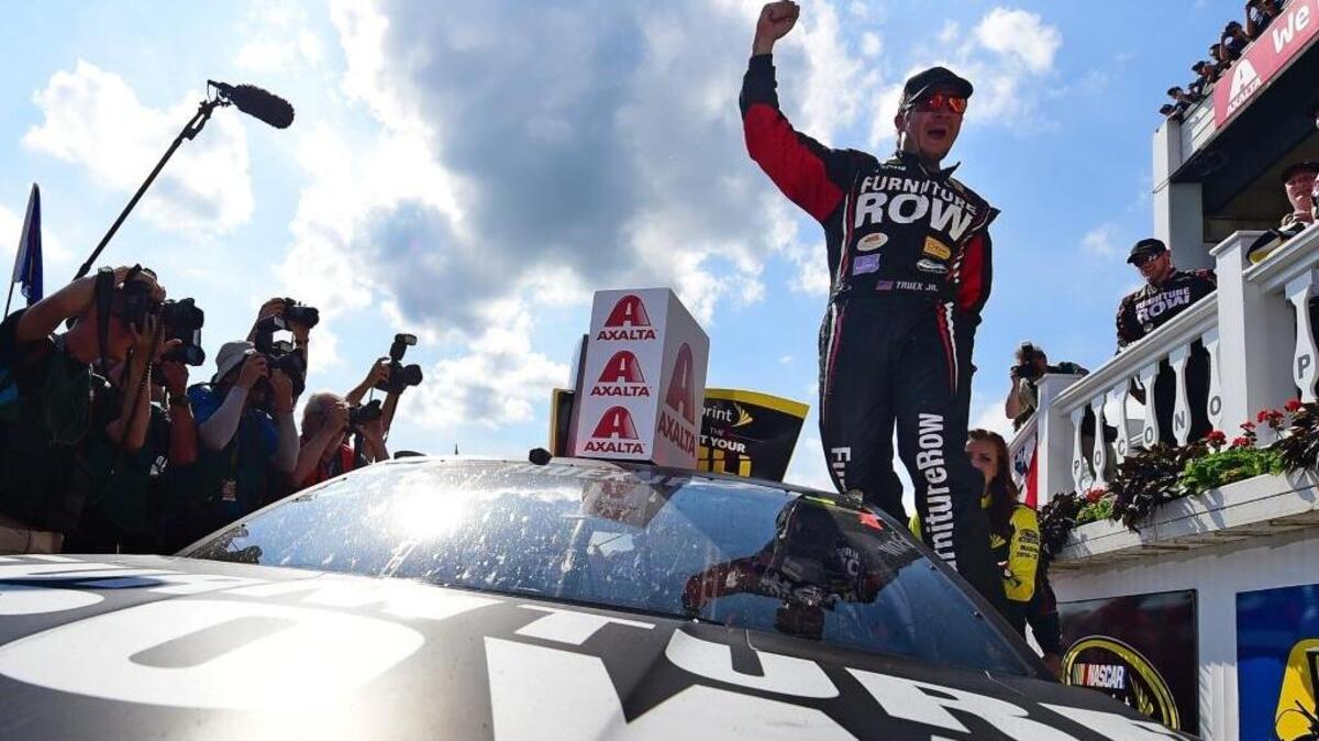 
Martin Truex Jr., driver of the #78 Furniture Row/Visser Precision Chevrolet, celebrates in Victory Lane after winning the NASCAR Sprint Cup Series Axalta “We Paint Winners” 400 at Pocono Raceway on June 7 in Long Pond, Pa.
